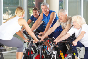 Seniors riding stationary bikes