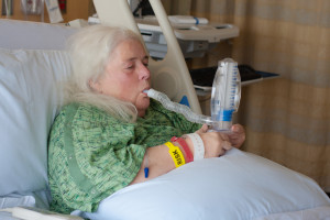 patient in bed with spirometer